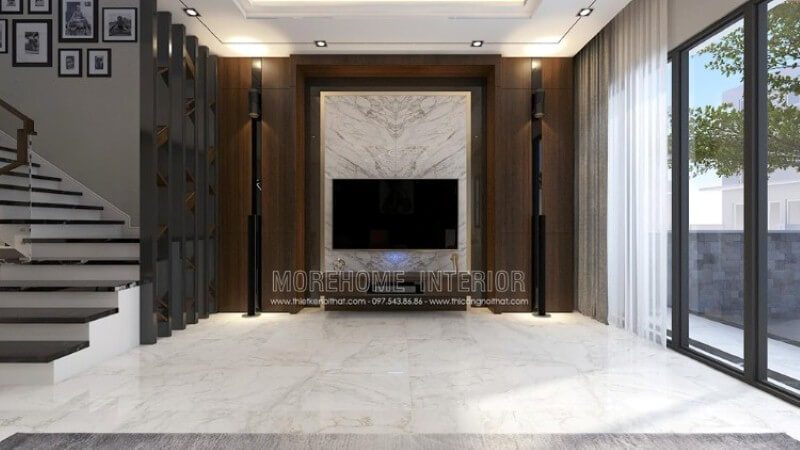 Trang trí nội thất phòng khách đẹp, sang trọng với ý tưởng sử dụng khối  đá trắng lớn đối vân ốp tường phòng khách được tôn lên bởi vẻ đẹp trầm từ mảng tường gỗ.